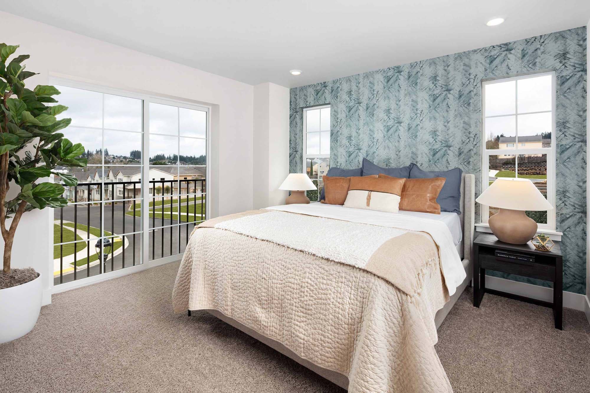 fresh and modern primary bedroom with wide double windows at The Rows at Axiom